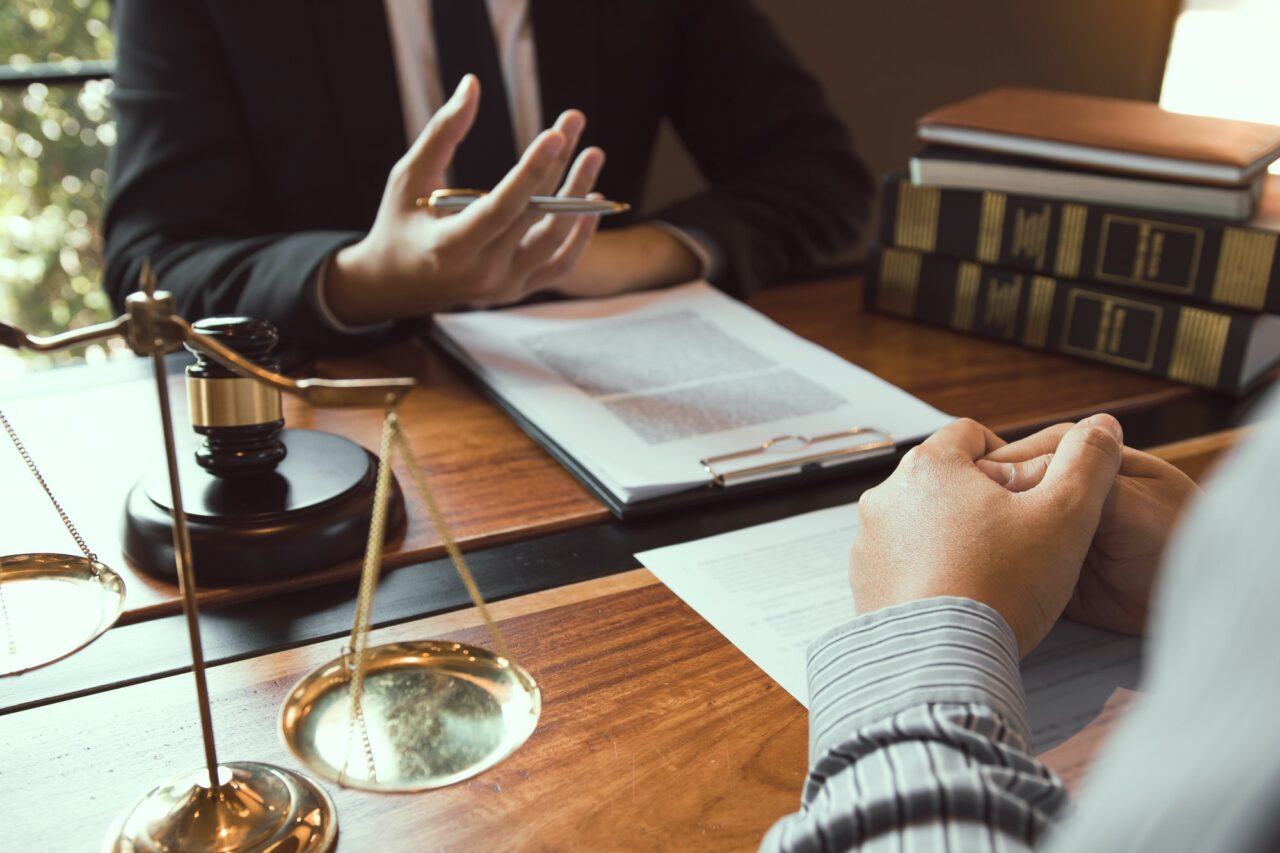 legal-advisor-is-explaining-the-offense-under-the-law-in-the-book-at-office-